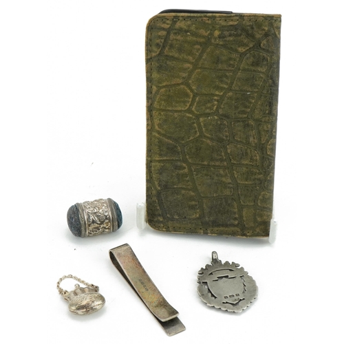 425 - Edwardian and later silver objects including a silver mounted leather purse, sport's jewel, money cl... 