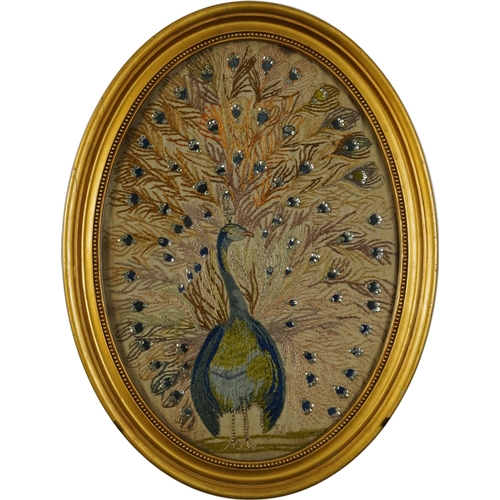 85 - Georgian oval embroidery of a peacock embellished with sequins and dated 1791, glazed, housed in a g... 