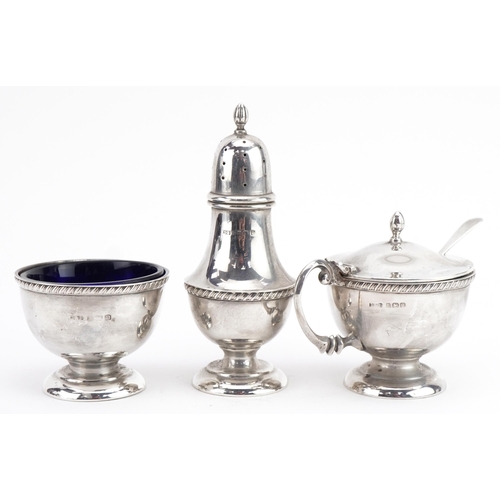 226 - Docker & Burn Ltd, George V silver three piece cruet with blue glass liners, Birmingham 1928, the ca... 