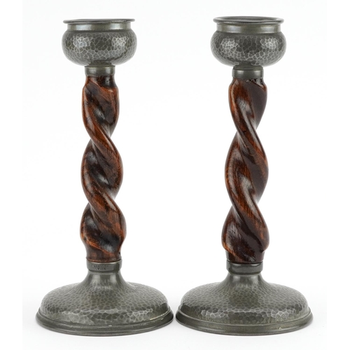 394 - Warston, pair of Arts & Crafts planished pewter and oak barley twist candlesticks, each 20.5cm high