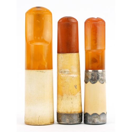 80 - Three early 20th century cigarette holders with amber coloured mouthpieces, two with silver mounts, ... 