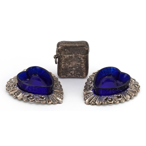 513 - William Henry Leather, pair of silver love heart shaped open salts with blue glass liners and a silv... 