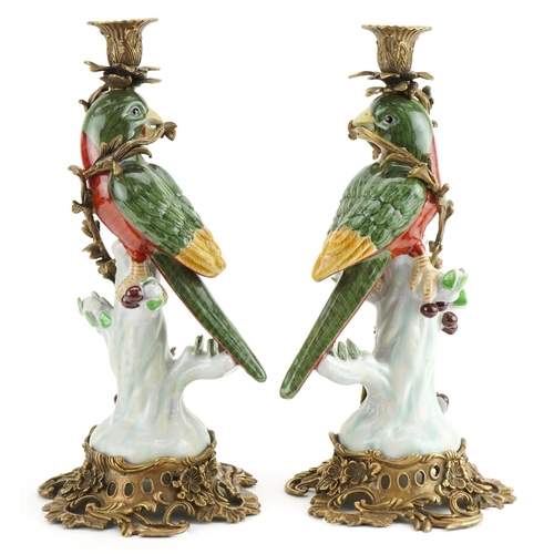 314 - Pair of continental porcelain bird design candlesticks with gilt bronze mounts, each 36cm high