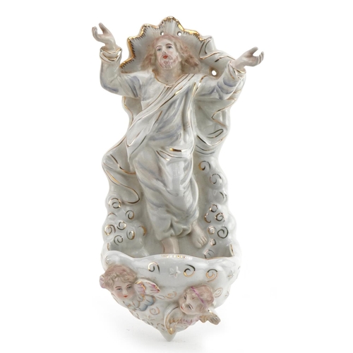 1379 - Continental porcelain holy water font with Christ and Putti, 27cm high