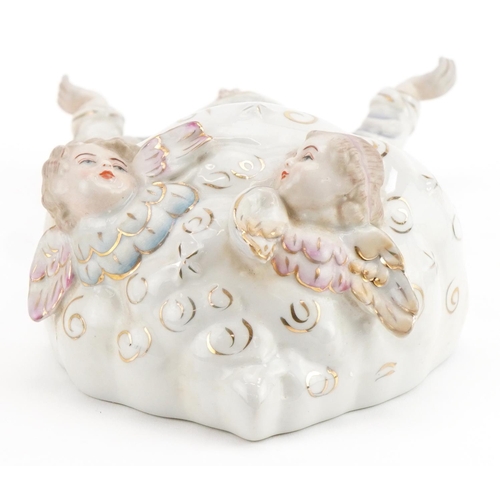 1379 - Continental porcelain holy water font with Christ and Putti, 27cm high