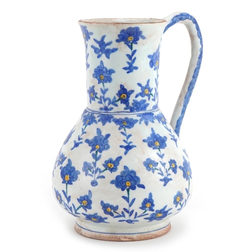 57 - Turkish Ottoman Kutahya pottery water jug hand painted with stylised flowers, 23cm high