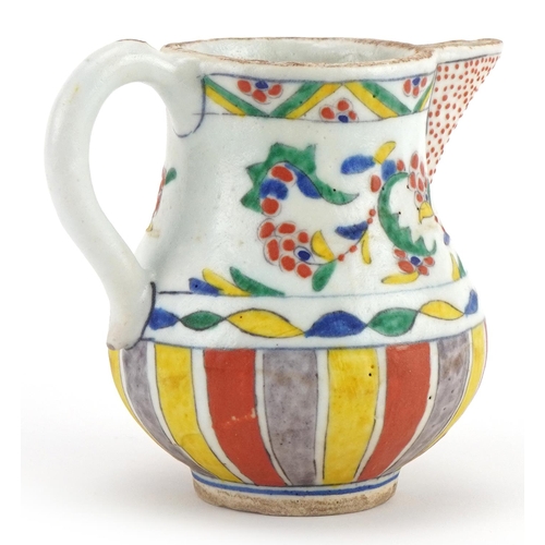 172 - Turkish pottery milk jug hand painted with stylised flowers and motifs, 12cm high