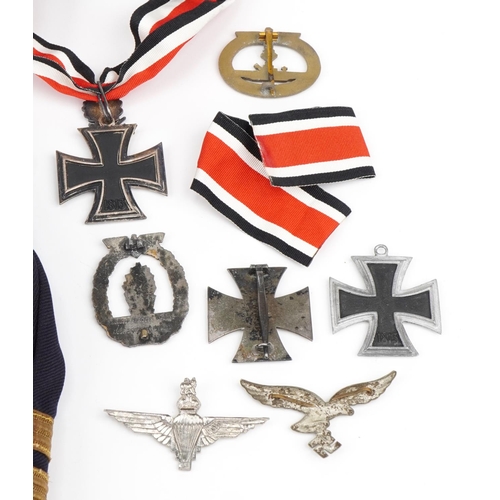 1741 - Militaria including two naval peak caps German badges and a tunic with German cloth badge