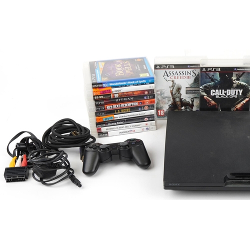 Sony PlayStation 3 games console with two controllers and a collection