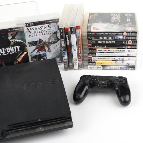 Sony PlayStation 3 games console with two controllers and a collection