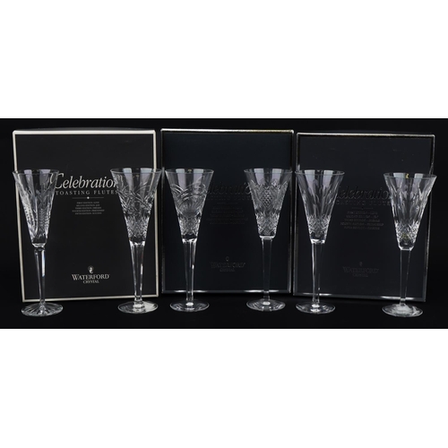 1097 - Six Waterford Crystal toasting flutes housed in celebration boxes, the largest 26cm high