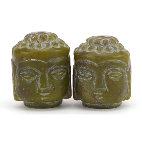 1367 - Pair of Chinese green hardstone beads in the form of a Buddha head, 3cm high, 52.4g