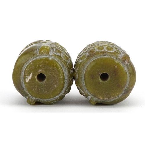 1367 - Pair of Chinese green hardstone beads in the form of a Buddha head, 3cm high, 52.4g