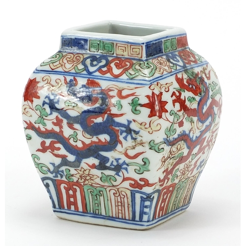 327 - Chinese wucai porcelain square section vase hand painted with dragons, six figure character marks to... 