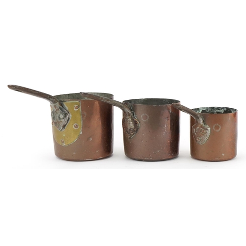 232 - Three 19th century copper saucepans by Jones Bros, Downing Street, the largest 24.5cm in length