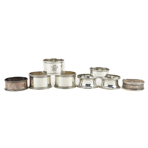 426 - Eight circular silver napkin rings, various hallmarks, the largest 4.8cm in diameter, total 119.0g