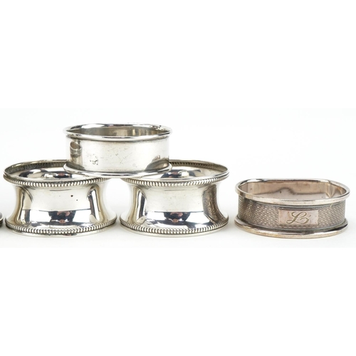 426 - Eight circular silver napkin rings, various hallmarks, the largest 4.8cm in diameter, total 119.0g