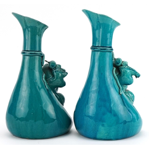 158 - Matched pair of Chinese sack design vases surmounted with figures having turquoise glazes, each 26.5... 