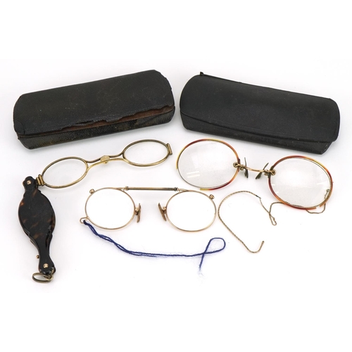 417 - Three pairs of early 20th century spectacles comprising one with tortoiseshell handle and two yellow... 