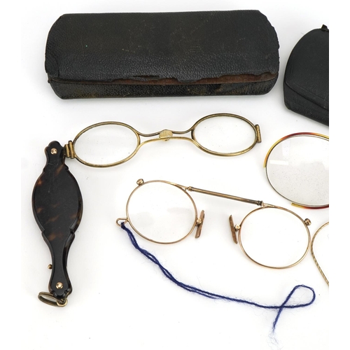 417 - Three pairs of early 20th century spectacles comprising one with tortoiseshell handle and two yellow... 