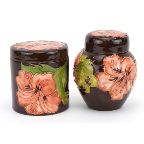 89 - Moorcroft pottery hand painted in the Coral Hibiscus pattern comprising ginger jar and cover, cylind... 