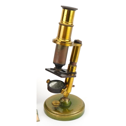 402 - Miniature Victorian adjustable brass microscope with prepared insect slides, housed in a mahogany ca... 