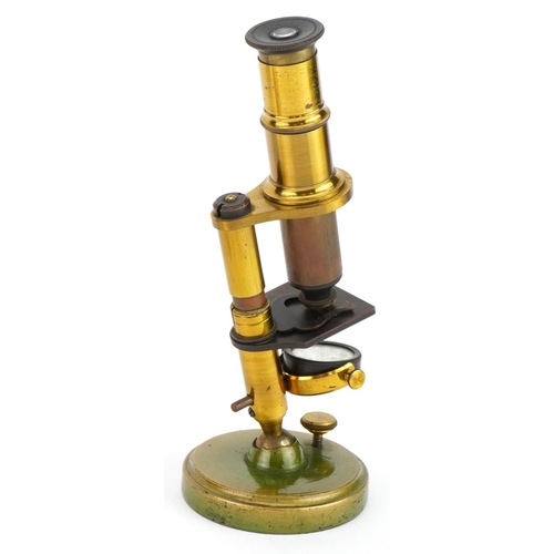 402 - Miniature Victorian adjustable brass microscope with prepared insect slides, housed in a mahogany ca... 