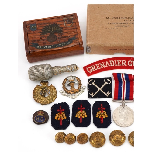 1727 - Militaria including World War II medal with box of issue, Grenadier Guards shoulder title, cap badge... 