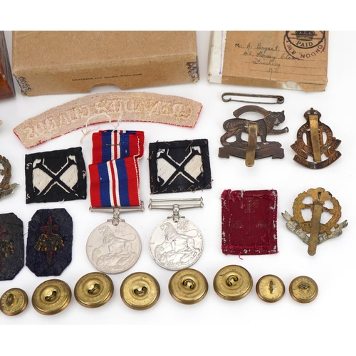 1727 - Militaria including World War II medal with box of issue, Grenadier Guards shoulder title, cap badge... 