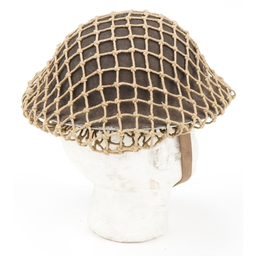 1743 - Military interest tin helmet with liner and netting