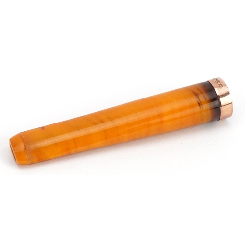 243 - Butterscotch amber cigarette holder with 9ct gold mount and velvet lined tooled leather case, 6.5cm ... 