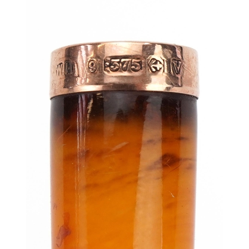 243 - Butterscotch amber cigarette holder with 9ct gold mount and velvet lined tooled leather case, 6.5cm ... 