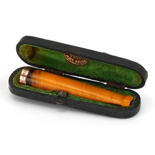 243 - Butterscotch amber cigarette holder with 9ct gold mount and velvet lined tooled leather case, 6.5cm ... 