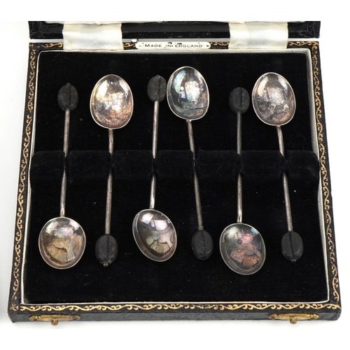 516A - Set of six silver teaspoons and matching sugar tongs and a set of six silver coffee bean spoons, eac... 