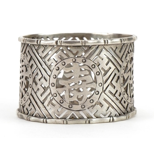 111 - Circular Chinese silver napkin ring pierced and engraved with character marks, 4.5cm in diameter, 24... 