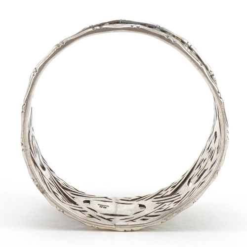 111 - Circular Chinese silver napkin ring pierced and engraved with character marks, 4.5cm in diameter, 24... 