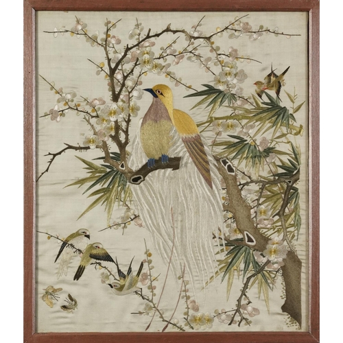 220 - Birds of paradise amongst blossom trees, pair of Chinese silk embroideries, each framed, the largest... 