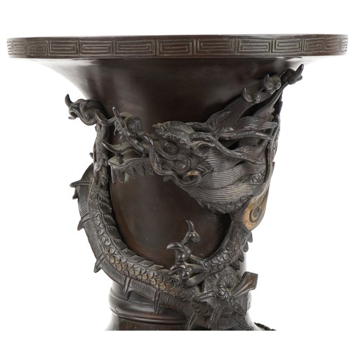 282 - Large Japanese patinated bronze vase decorated in relief with a dragon and phoenix amongst trees, 56... 