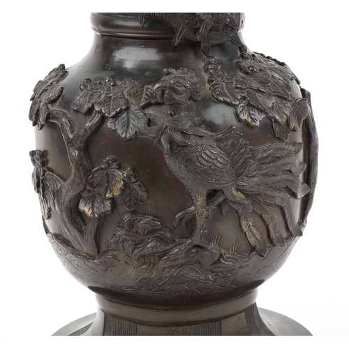 282 - Large Japanese patinated bronze vase decorated in relief with a dragon and phoenix amongst trees, 56... 