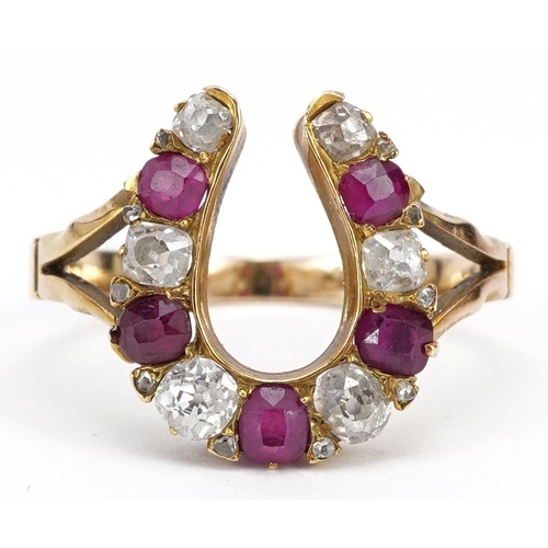 2001 - 19th century unmarked gold diamond and ruby horseshoe ring, tests as 18ct gold, the largest diamond ... 