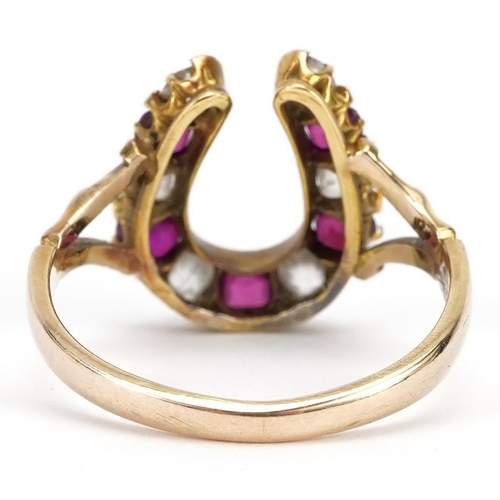2001 - 19th century unmarked gold diamond and ruby horseshoe ring, tests as 18ct gold, the largest diamond ... 