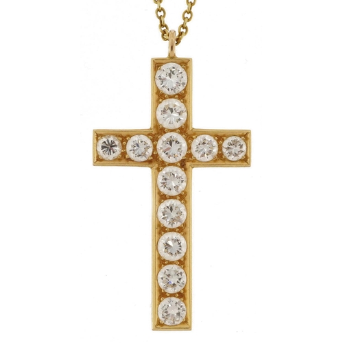 2004 - Unmarked gold cross pendant set with twelve diamonds of varying sizes, the largest diamond approxima... 