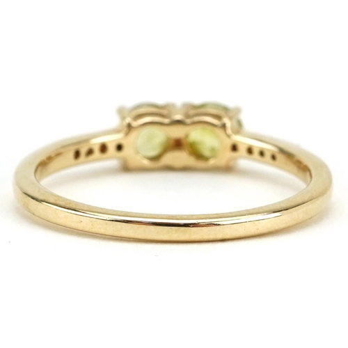 2309 - 9ct gold peridot two stone ring with clear stone set shoulders, each peridot approximately 4.3mm in ... 