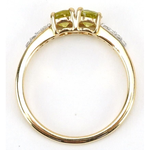 2309 - 9ct gold peridot two stone ring with clear stone set shoulders, each peridot approximately 4.3mm in ... 