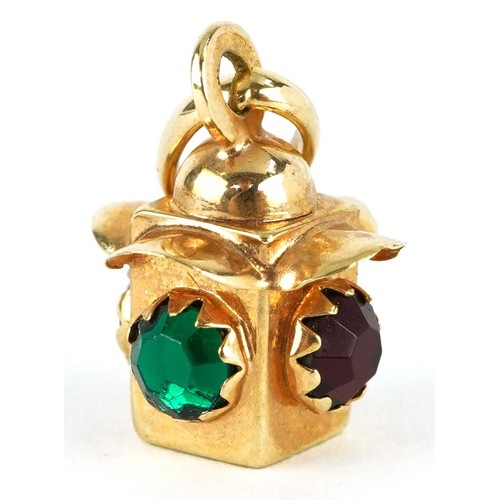 2320 - 9ct gold lantern charm set with red and green stones, 2.2cm high, 2.0g