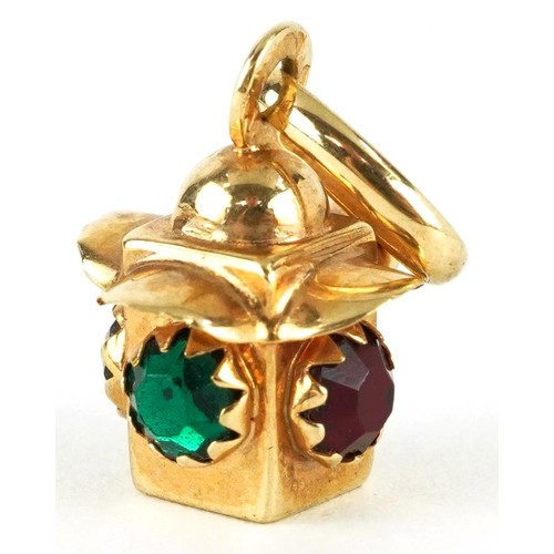 2320 - 9ct gold lantern charm set with red and green stones, 2.2cm high, 2.0g