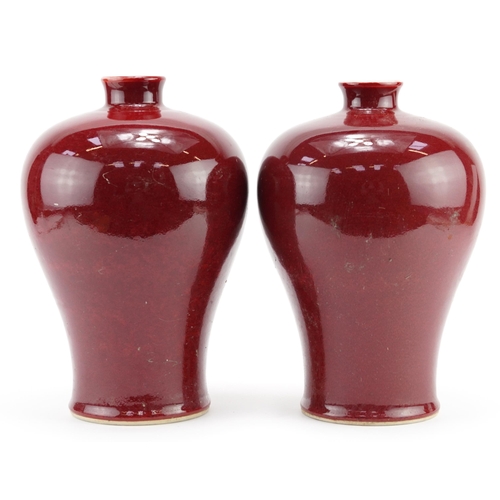 325 - Pair of Chinese porcelain baluster vases having sang de boeuf glazes, each 29cm high