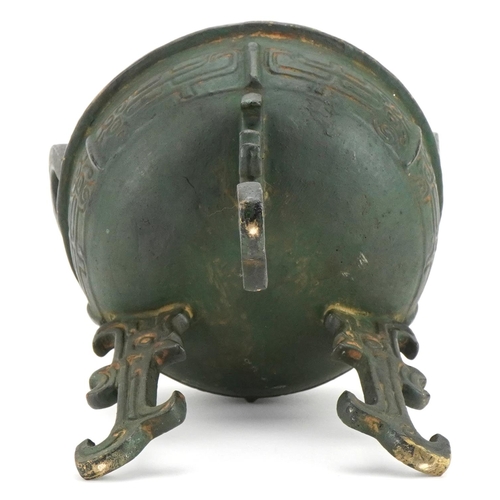 1330 - Chinese archaic style bronzed tripod censer with twin handles, 18cm high