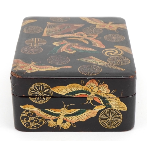 128 - Japanese lacquered box and cover gilded with butterflies amongst fans and stylised roundels, 5cm x 1... 