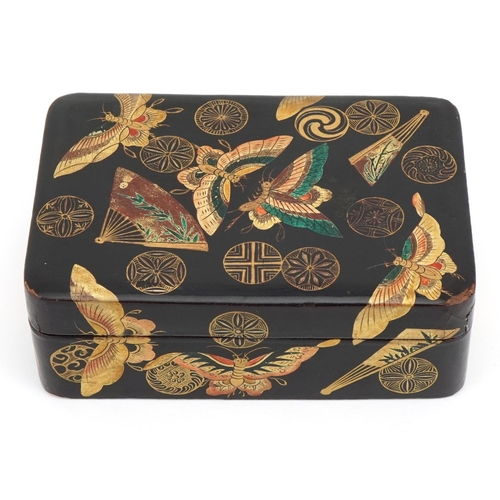 128 - Japanese lacquered box and cover gilded with butterflies amongst fans and stylised roundels, 5cm x 1... 